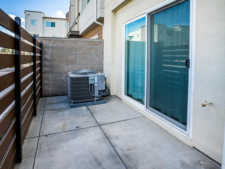 Patio with sliding door entrance to first floor bedroom.