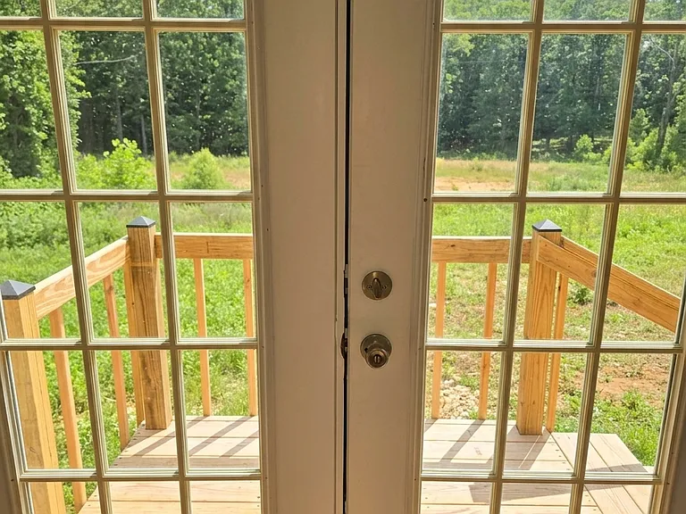 French doors and small deck off the bedroom