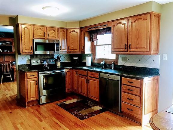 Kitchen with granite and stainless steel appliances.