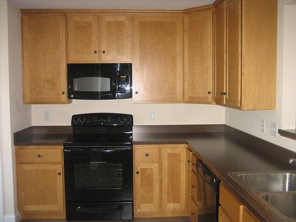 Kitchen with tall maple cabinets, tile floor