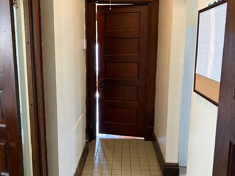 hallway facing bedroom door off of living room