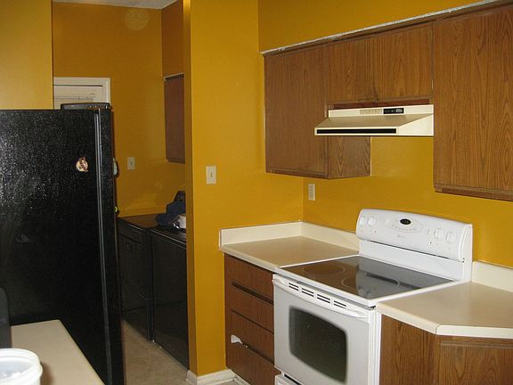 Kitchen with Fridge - and Laundry area with pantry and washer dryer. 