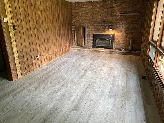 Spacious living room with new flooring, plenty of light and lots of charm!