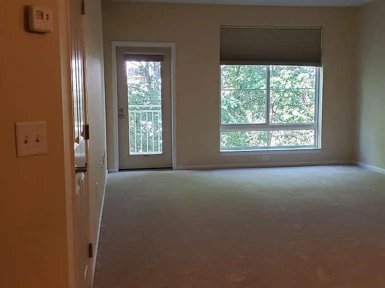 Livingroom looks out to the privately treed view and access door to the deck