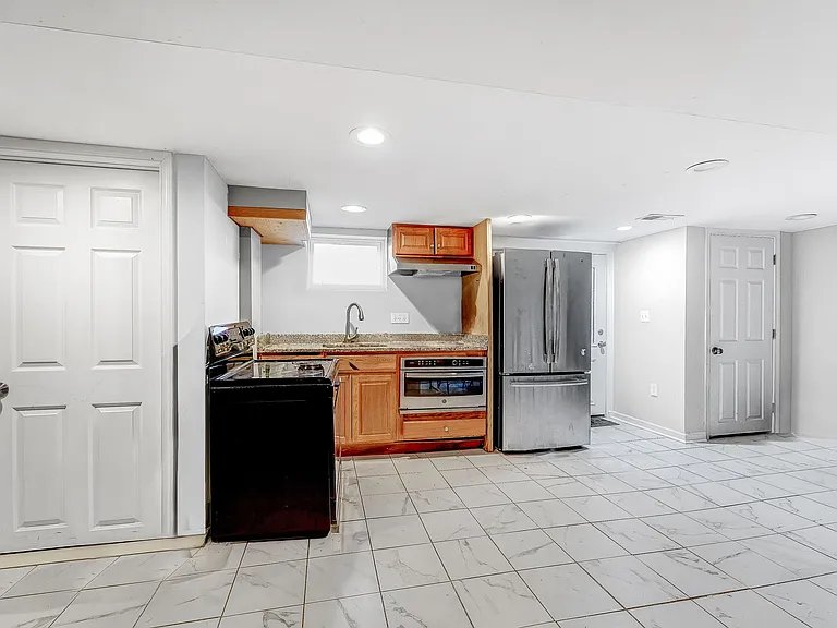 Exit to rear yard to right of refrigerator-freezer; large storage closet on right and full bathroom on left