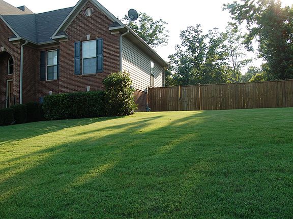 side of home.  View of fence