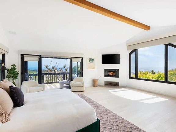 Master bedroom flows with ocean views and private balcony.