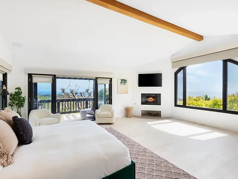 Master bedroom flows with ocean views and private balcony.