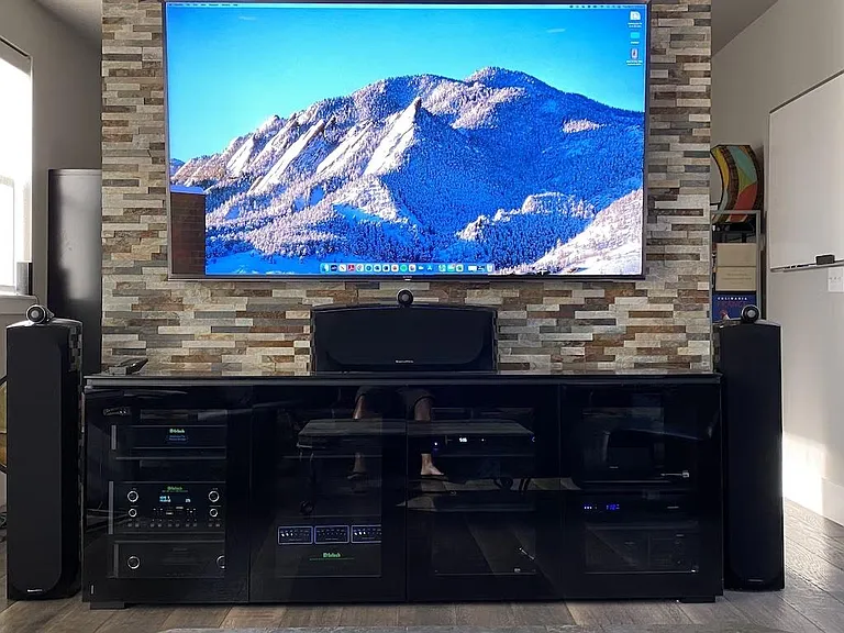 85" Sony TV, McIntosh components, B&W speakers. Full Dolby Atoms system. Office behind TV wall.