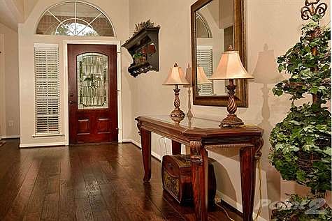 Open and inviting entryway boasts high ceilings and brand new wood floors.