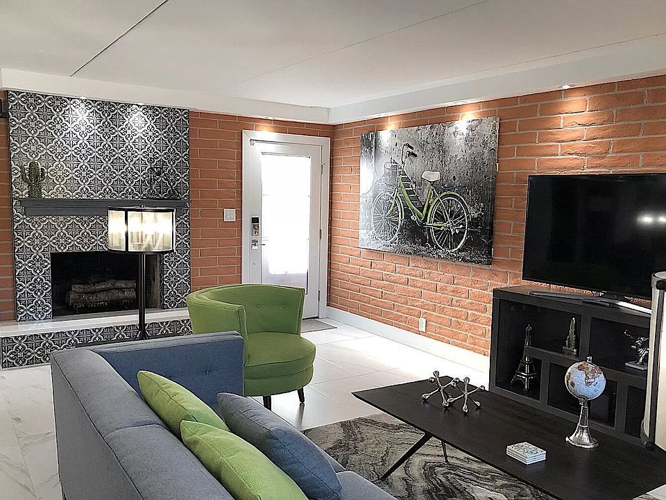 Living room with fireplace and TV