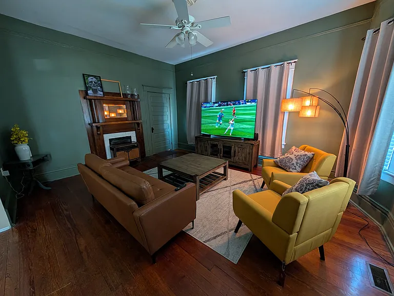 Homey den with furniture and included 75" TV.