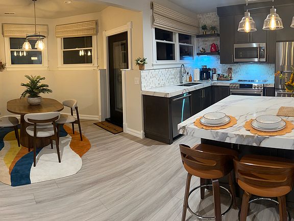 View of the kitchen with the dining area. See the entrance door off the dining area.
