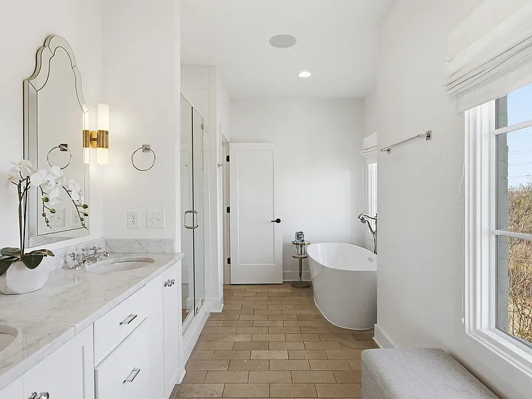 Full Bathroom connected to bedroom 1 with double vanity, shower, and large bathtub.