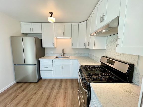New Kitchen with quartz countertops and new stainless refrigerator
