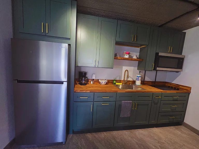 Modern kitchen with elegant colors and plenty of cabinet space.