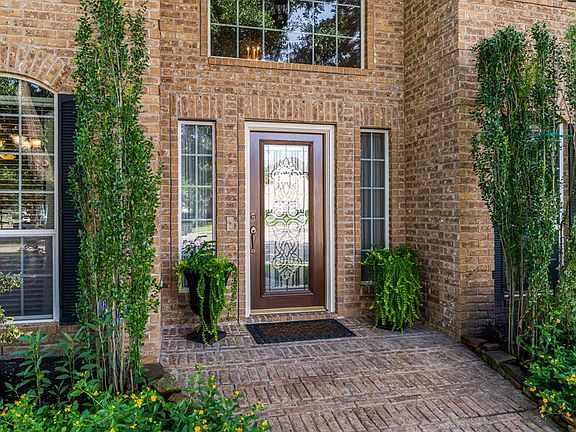 A brick patio along with a beautiful lead glass door leads the way into a immaculate move-in ready home.