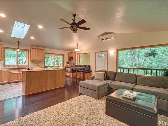 Great room with hardwood floors and vaulted ceilings.