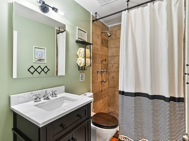 Second bathroom with a standing shower. We provide all towels during your 30+ day stay.