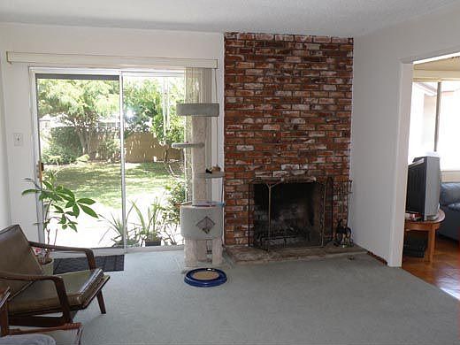 Living room with backyard access and brick fireplace