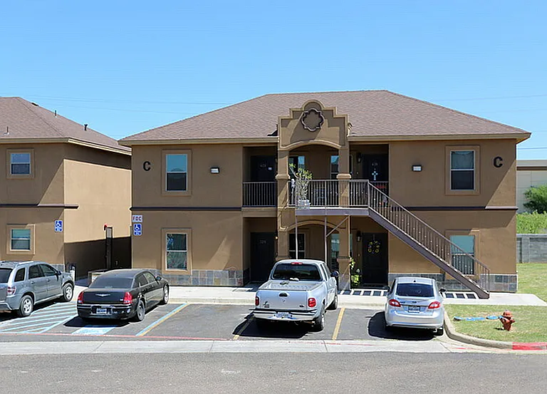 Merida Vista Apartments in Laredo, TX - Exterior Building Apartment C with Parked Cars