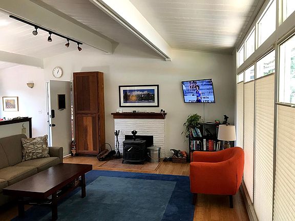 The living room straight ahead with the kitchen and door to the back deck to the right. Picture was taken from the entryway.