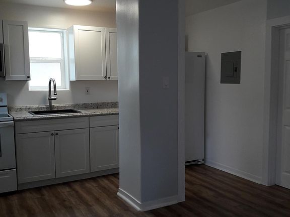 Open kitchen with granite sink and pantry storage