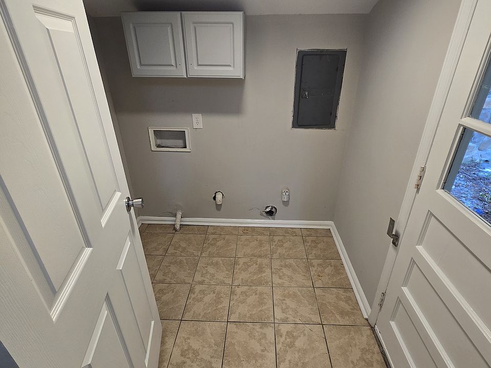 Laundry room as viewed from the kitchen, door to backyard.