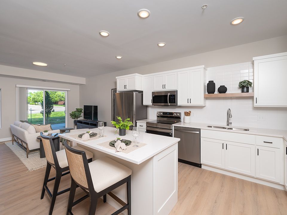 White cabinetry and an open kitchen layout designed for everyday cooking and connection.