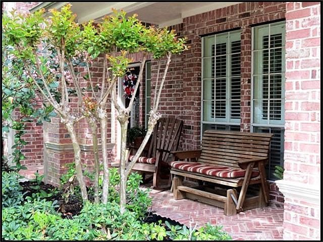 Covered front porch elevation located on a cul-de-sac lot.