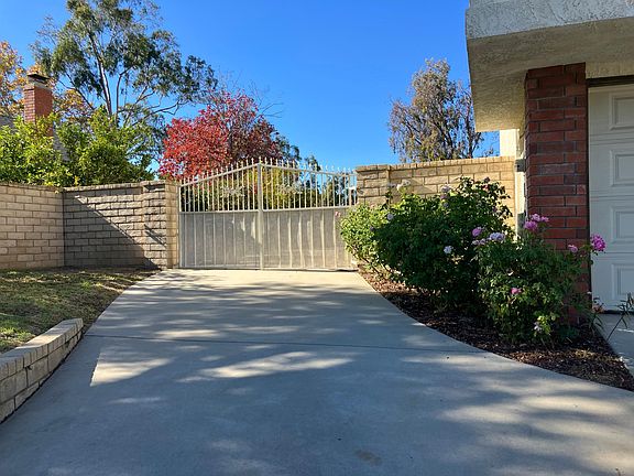 Side driveway with additioional parking behind gate
