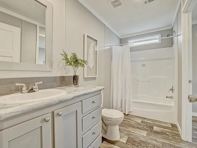 Second bathroom in hallway for other 2 bedrooms. It connects to the laundry room that has the back door.