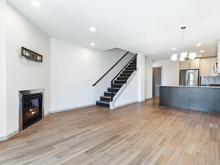 Wide plank flooring throughout lower level, main level, and staircase.