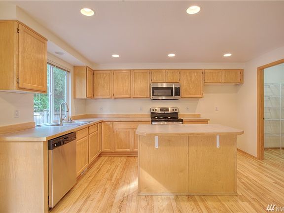 Island kitchen with brand new, stainless steel range, microwave & dishwasher.  Enjoy a new kitchen sink & faucet as well.  Large walk-in pantry for all your storage needs. 