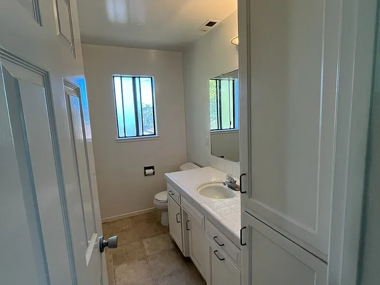 Upstairs half bathroom with cabinets