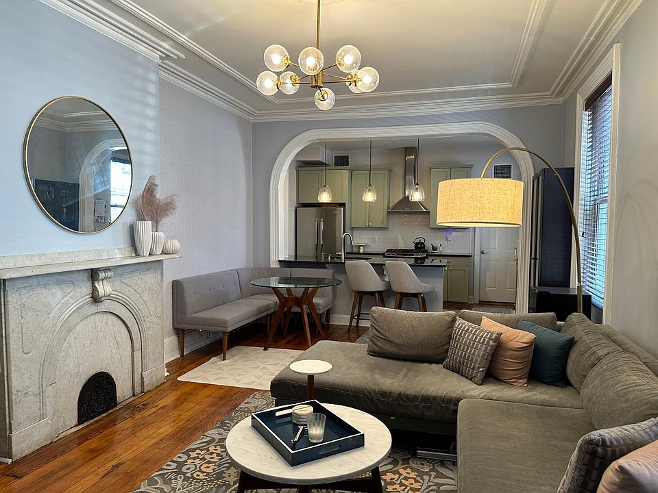 Living Room with original wood floors and decorative original fireplace