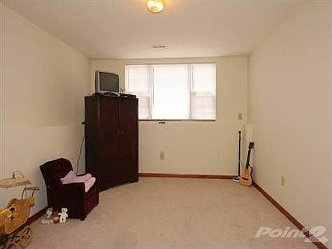 Family room with two large windows in lower level and half bath.