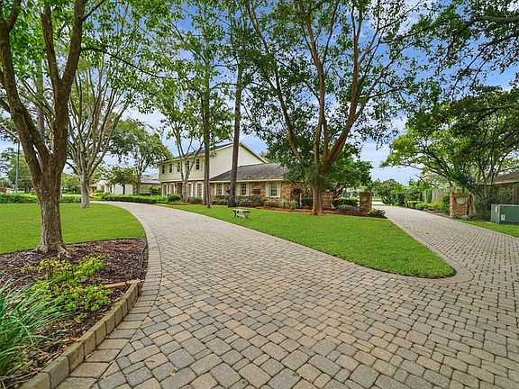 This home provides beautiful curb appeal with gorgeous, mature trees, plenty of greenspace and a lovely cobblestone paver drive that offers a circular car pathway in the front and connects to a driveway that leads to the back of the property to the o