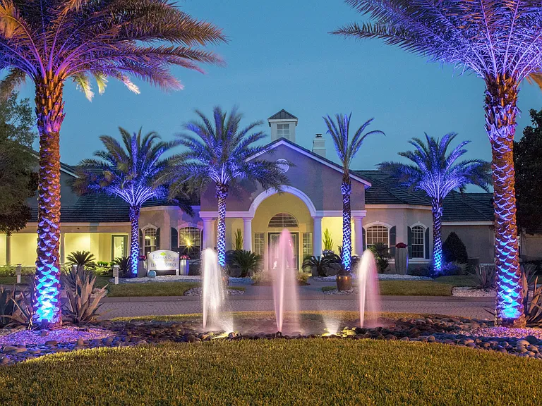 Step into an enchanting evening at Banyan Bay, where illuminated fountains and swaying palms welcome you to your paradise by the sea.