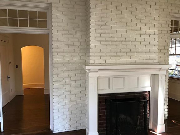 Fireplace at Sunroom; through French doors to Living Room and hallway