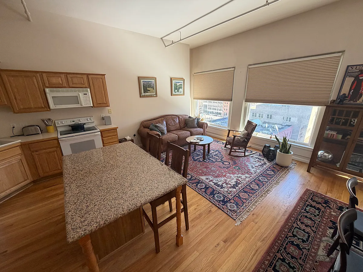 Large sunny windows look over iconic Denver skyscrapers. Open floor plan with elegant furnishings makes a comfortable environment for entertaining, relaxation, or work-from-home. - 1555 California St #603