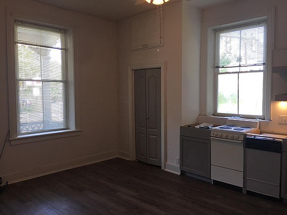 Front window with view to front porch. Closet door and window over stove.