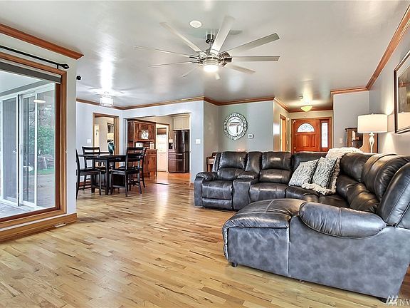 This shows the front entry, otherside of living room looking into the dining area, kithchen, doorway to laundry room and entry i