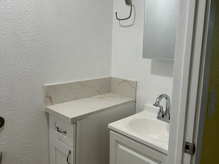 Half bathroom toilet/ sink down stairs.