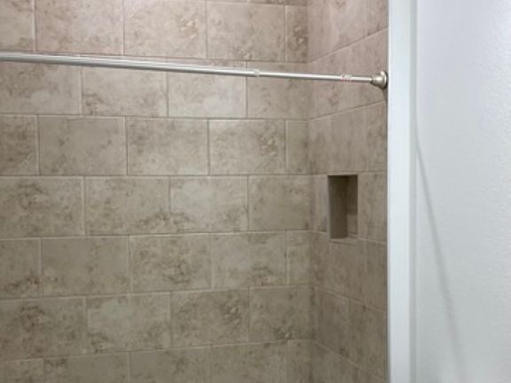 Guest Bathroom. Tiled to ceiling and floor is tiled.