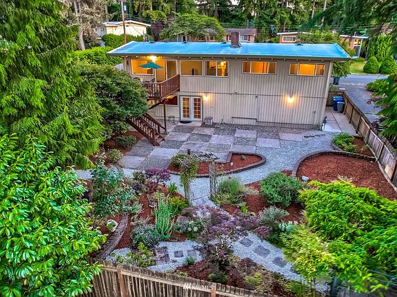 A backyard oasis! Charming gardens and vast patios are well kept