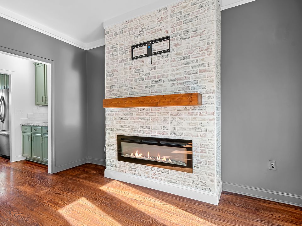 LED fireplace, wood mantle, TV mount, and outlet for easy TV installation
