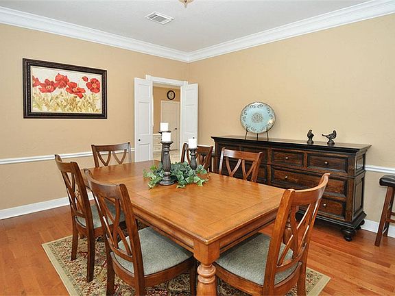 The large dining room has a 9' ceiling, wood flooring, chair rails, and crown molding.
