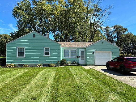 Street view of garage side with attached one-car garage with opener