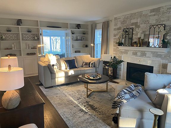 Family room with gas fireplace and French doors to sunroom
